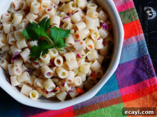Effortless 3-Ingredient Pasta Salad 3 A close-up overhead shot of the simple 3-ingredient quick pasta salad in a bowl, topped with fresh parsley for garnish, ready to serve.