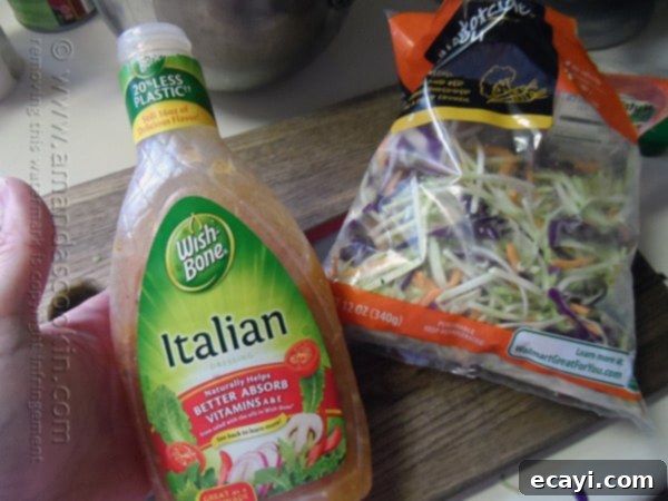 Effortless 3-Ingredient Pasta Salad 4 Ingredients for 3-Ingredient Quick Pasta Salad laid out: a box of pasta, a bag of broccoli slaw, and a bottle of salad dressing.