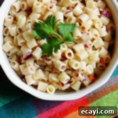 Effortless 3-Ingredient Pasta Salad 7 A close up overhead of three ingredient quick pasta salad in a bowl with fresh parley on top.