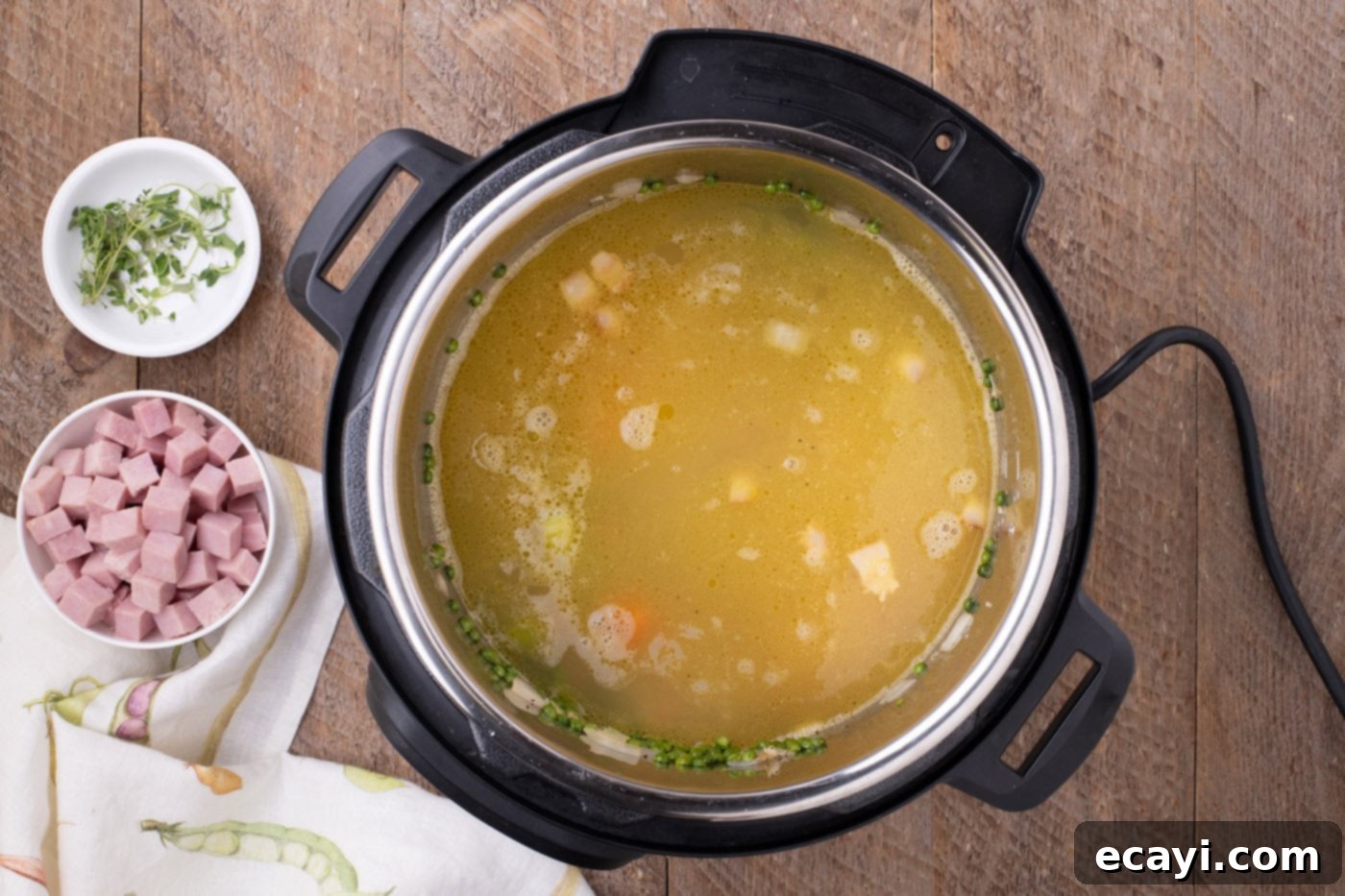 Hearty Instant Pot Split Pea Soup 8 Split peas and the majority of chicken stock added to the Instant Pot mixture, ready for pressure cooking.