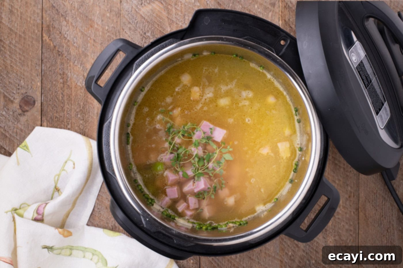 Hearty Instant Pot Split Pea Soup 9 Diced smoked ham and fresh thyme sprigs added to the Instant Pot, before sealing the lid for pressure cooking.