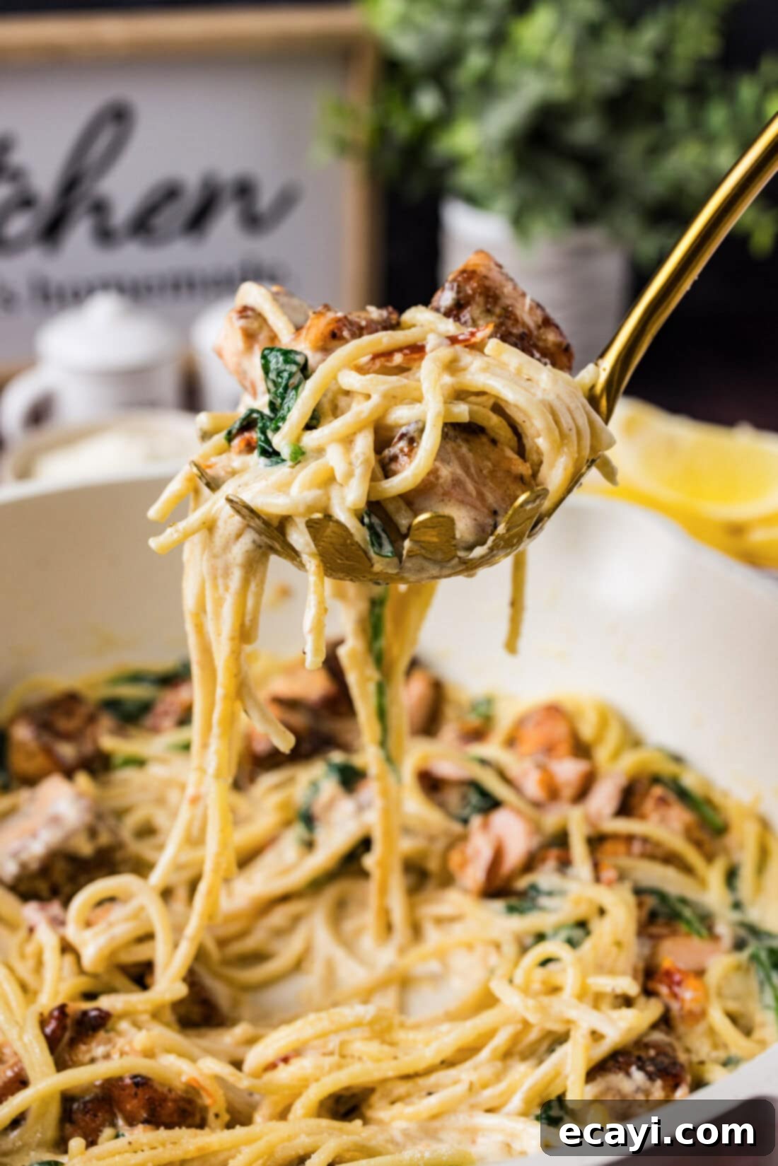 Mediterranean Salmon Pasta 3 Spoonful of Creamy Salmon Pasta held above a skillet of the finished dish