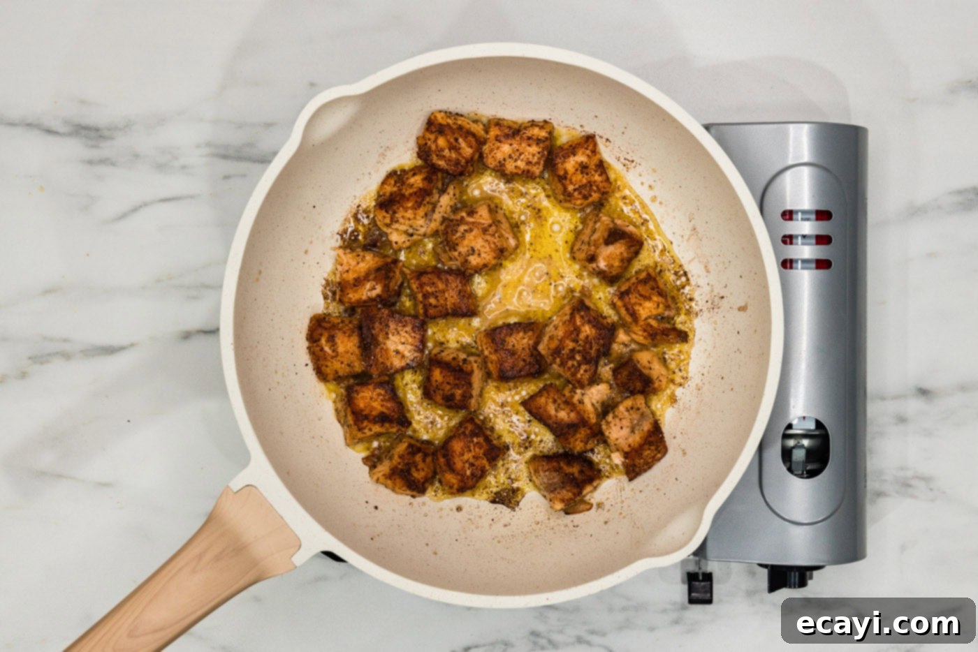 Mediterranean Salmon Pasta 6 cooked salmon cubes in a skillet