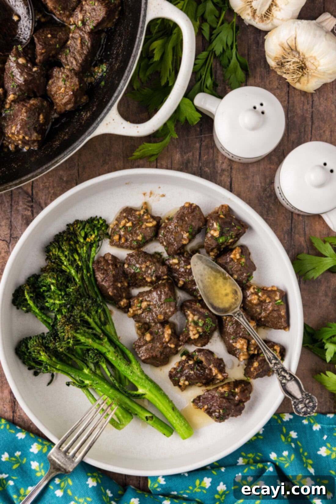 Mouthwatering Garlic Butter Steak Bites 3 Garlic Butter Steak Bites served on a white plate with fresh broccolini, showcasing a complete and appetizing meal.