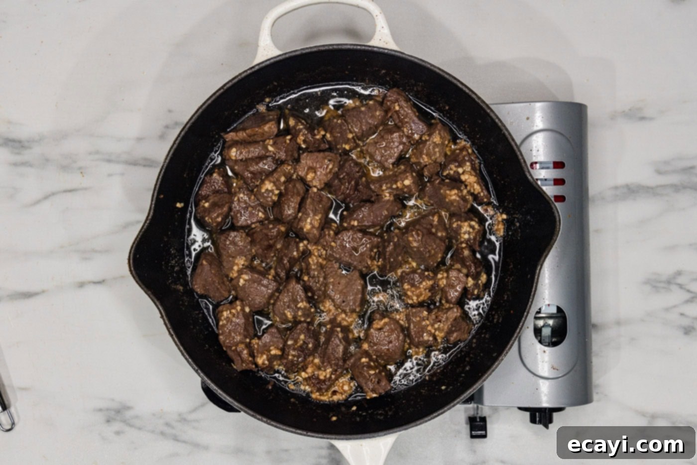 Mouthwatering Garlic Butter Steak Bites 9 Overhead view of garlic butter steak bites in a skillet, showcasing the completed dish with its rich, glossy sauce.