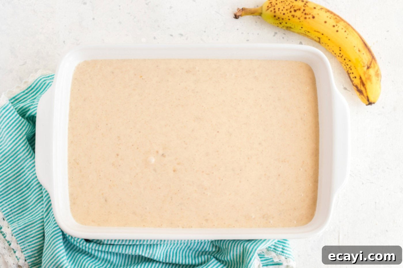 Effortless Banana Cake 7 cake batter poured into a 13x9 inch baking pan, ready for the oven