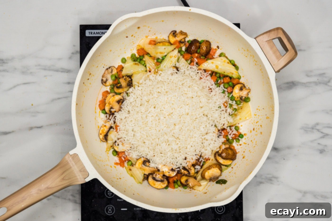 Savory Korean Fried Rice 7 Cooked white rice being added to a skillet with stir-fried vegetables and aromatics