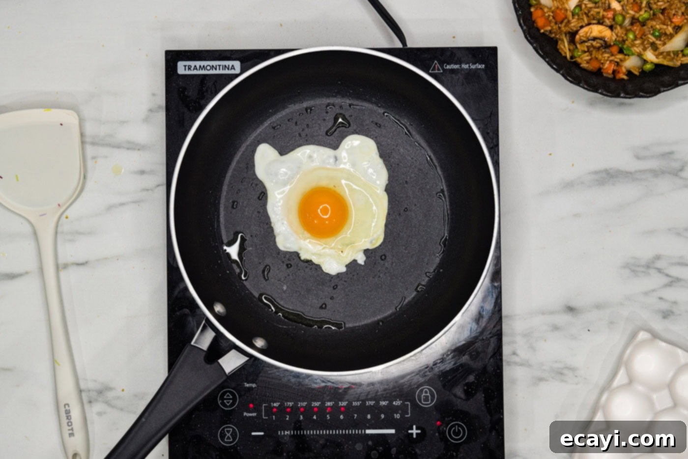 Savory Korean Fried Rice 9 A perfectly cooked sunny side up egg sizzling in a hot skillet, ready to top the fried rice