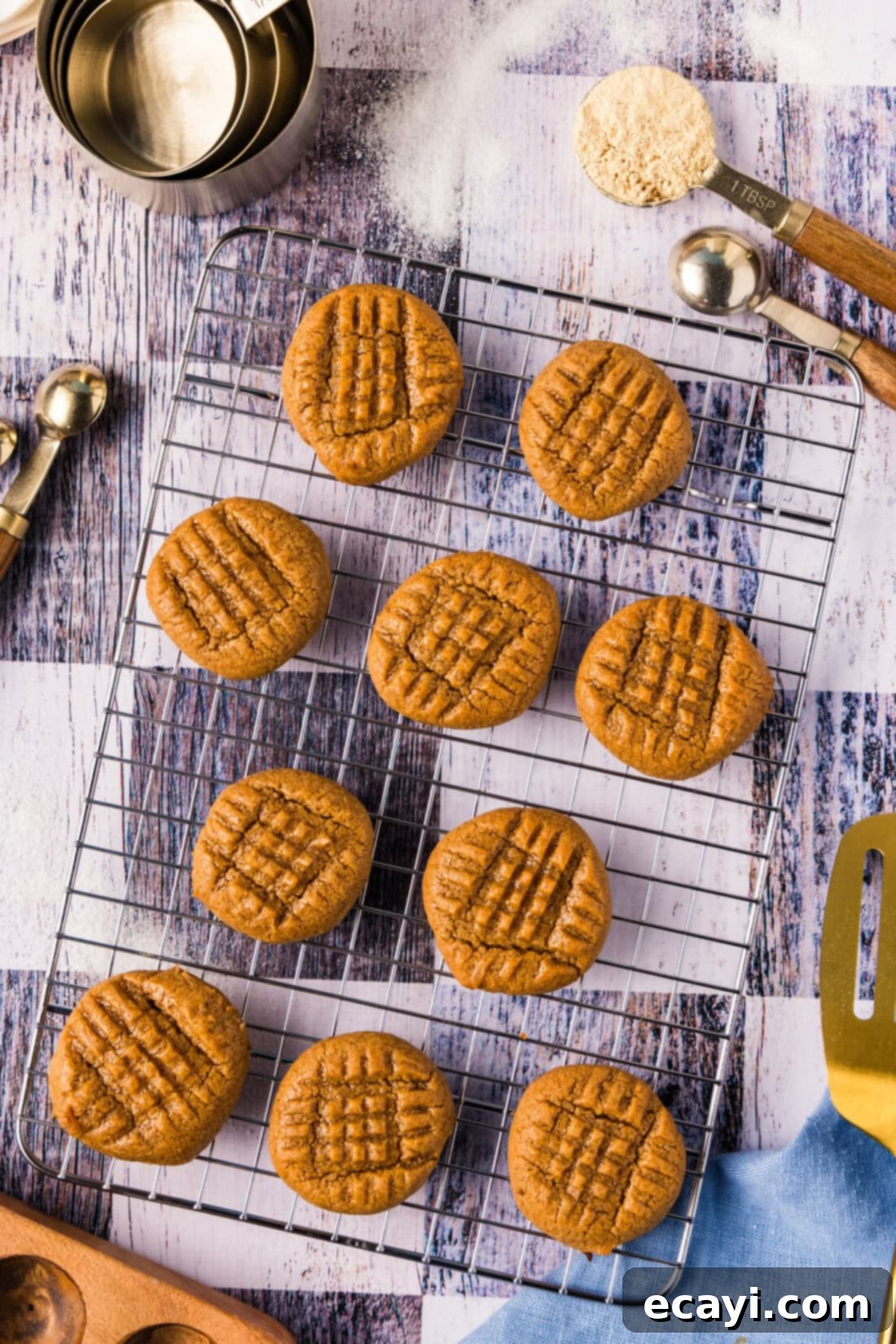 Guilt-Free Keto Peanut Butter Treats 2 Keto Peanut Butter Cookies resting on a wire rack, showcasing their golden-brown edges and classic fork marks