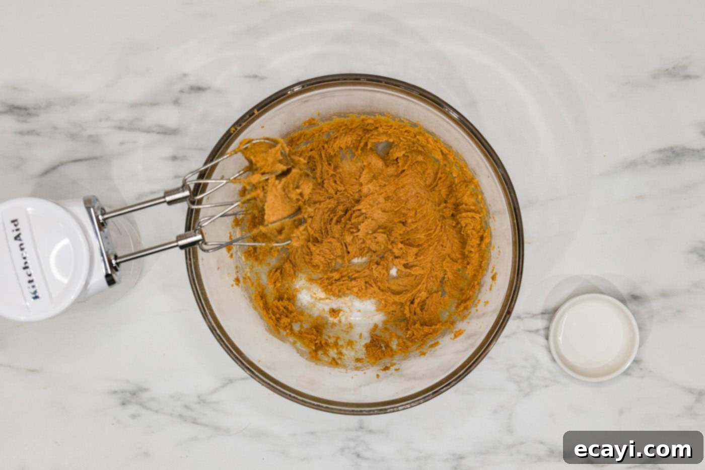 Guilt-Free Keto Peanut Butter Treats 6 keto peanut butter cookie dough in a bowl being mixed with a hand mixer whisk, showing its forming texture