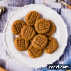 Guilt-Free Keto Peanut Butter Treats 9 Plate of Keto Peanut Butter Cookies, perfectly golden with classic fork marks