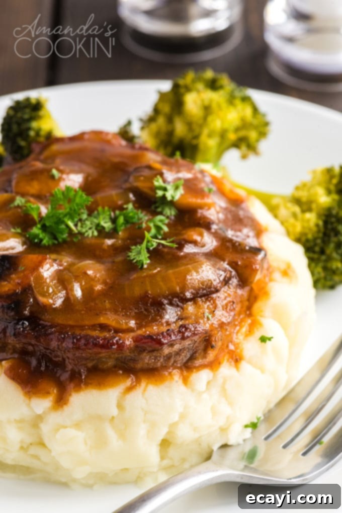 This oven Swiss steak is a delicious twist on a vintage classic. It uses fresh mushrooms and plenty of beef broth for flavor. A comforting, updated recipe! Tender oven Swiss steak and savory mushroom gravy piled on creamy mashed potatoes