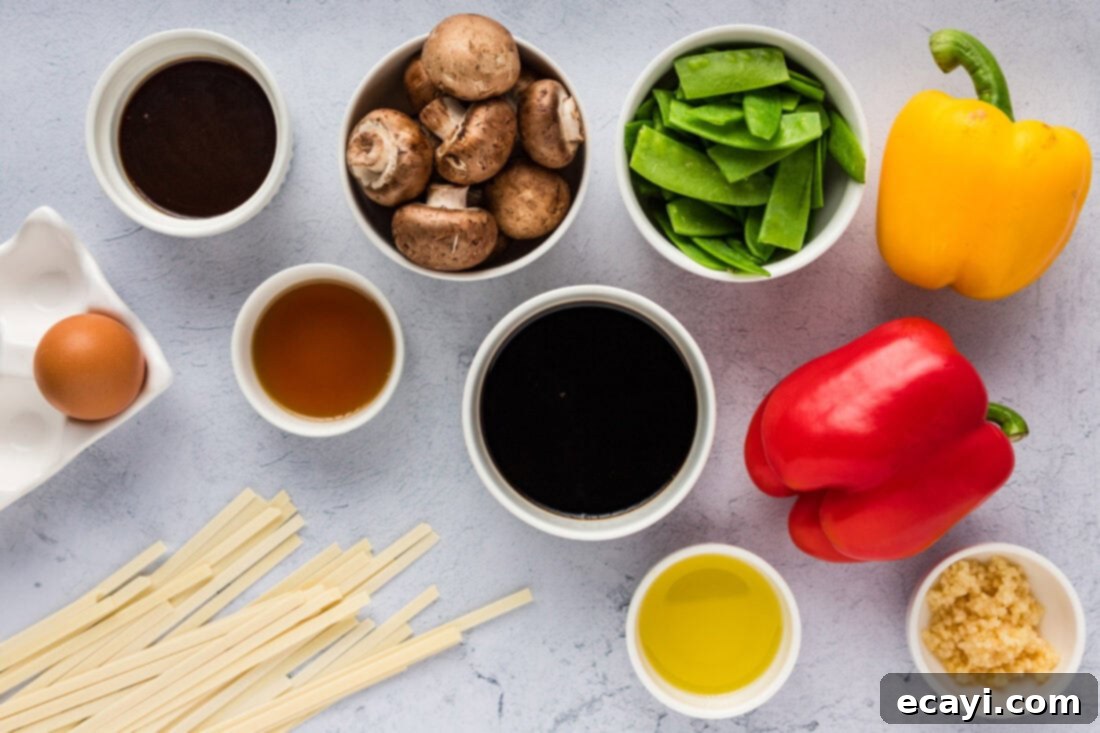 Savory Vegetable Lo Mein 4 A selection of fresh ingredients laid out, including bell peppers, snow peas, mushrooms, noodles, and sauces, ready for Vegetable Lo Mein
