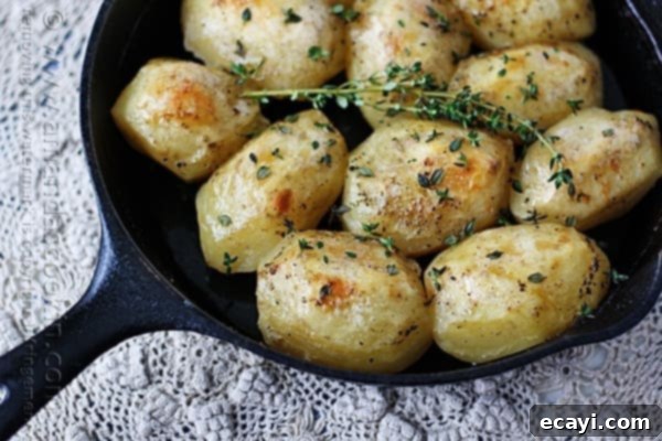 Crispy Cast Iron Roast Potatoes 2 Golden brown crispy roast potatoes in a cast iron skillet, looking incredibly appetizing and ready to serve.