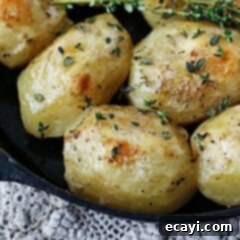 Crispy Cast Iron Roast Potatoes 9 A close up photo of roast potatoes in a cast iron skillet, golden and perfectly cooked for a hearty meal.