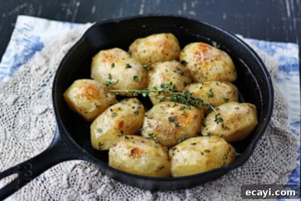 Crispy Cast Iron Roast Potatoes 3 Close-up of rustic cast iron skillet roast potatoes garnished with fresh herbs, looking incredibly inviting.