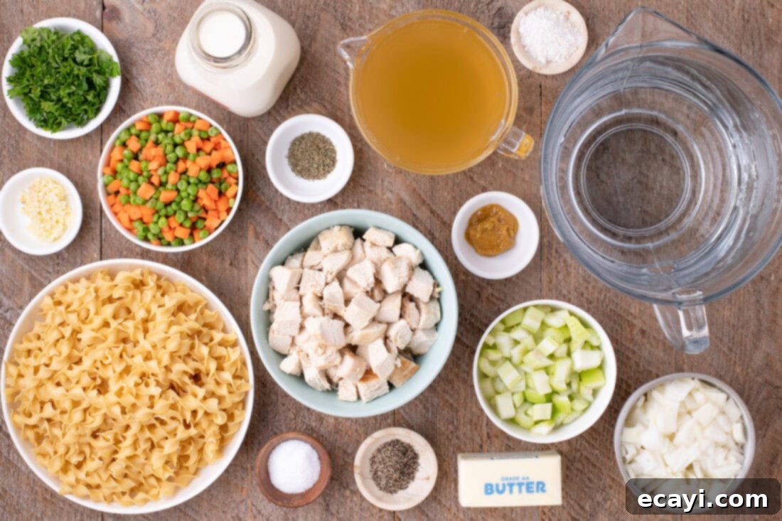 Hearty Chicken Pot Pie Pasta 4 Fresh ingredients laid out for making Chicken Pot Pie Pasta: chicken, vegetables, pasta, and seasonings