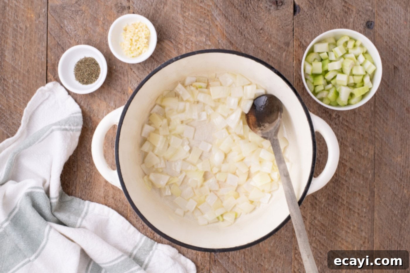 Hearty Chicken Pot Pie Pasta 5 satueeing onions in a cast iron pot until translucent