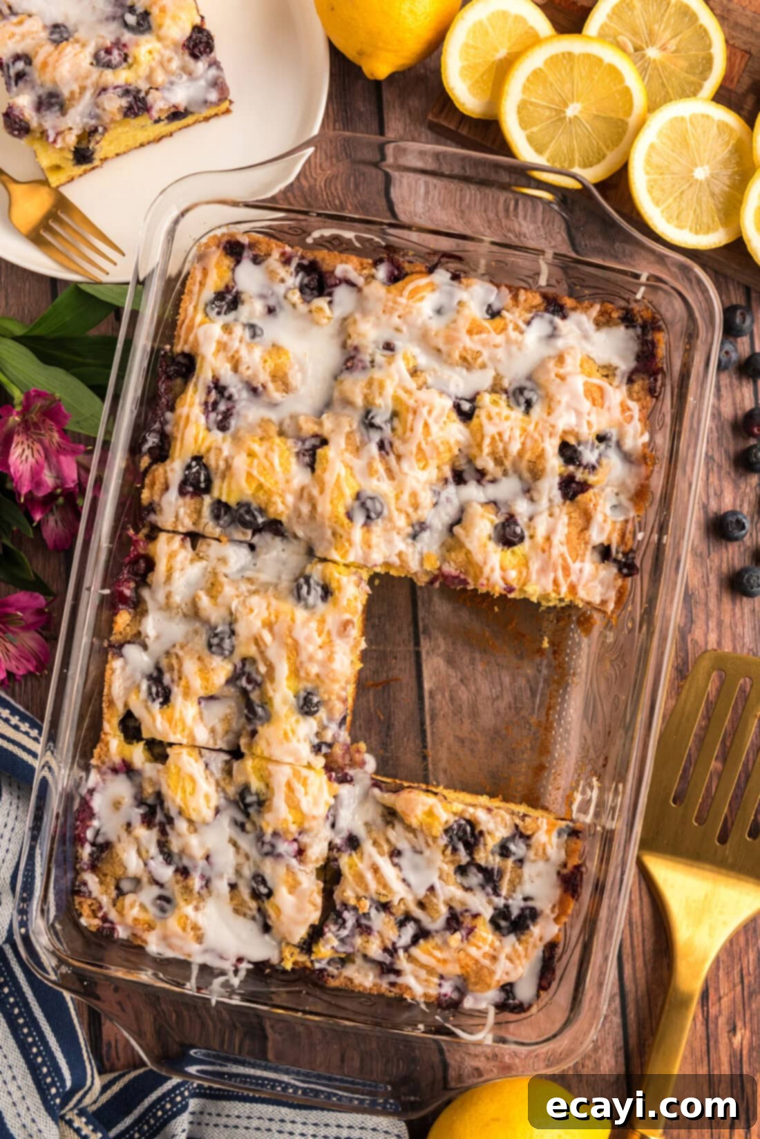 Tender Blueberry Cake with Zesty Lemon Glaze 2 Glazed Lemon Blueberry Cake with a slice removed