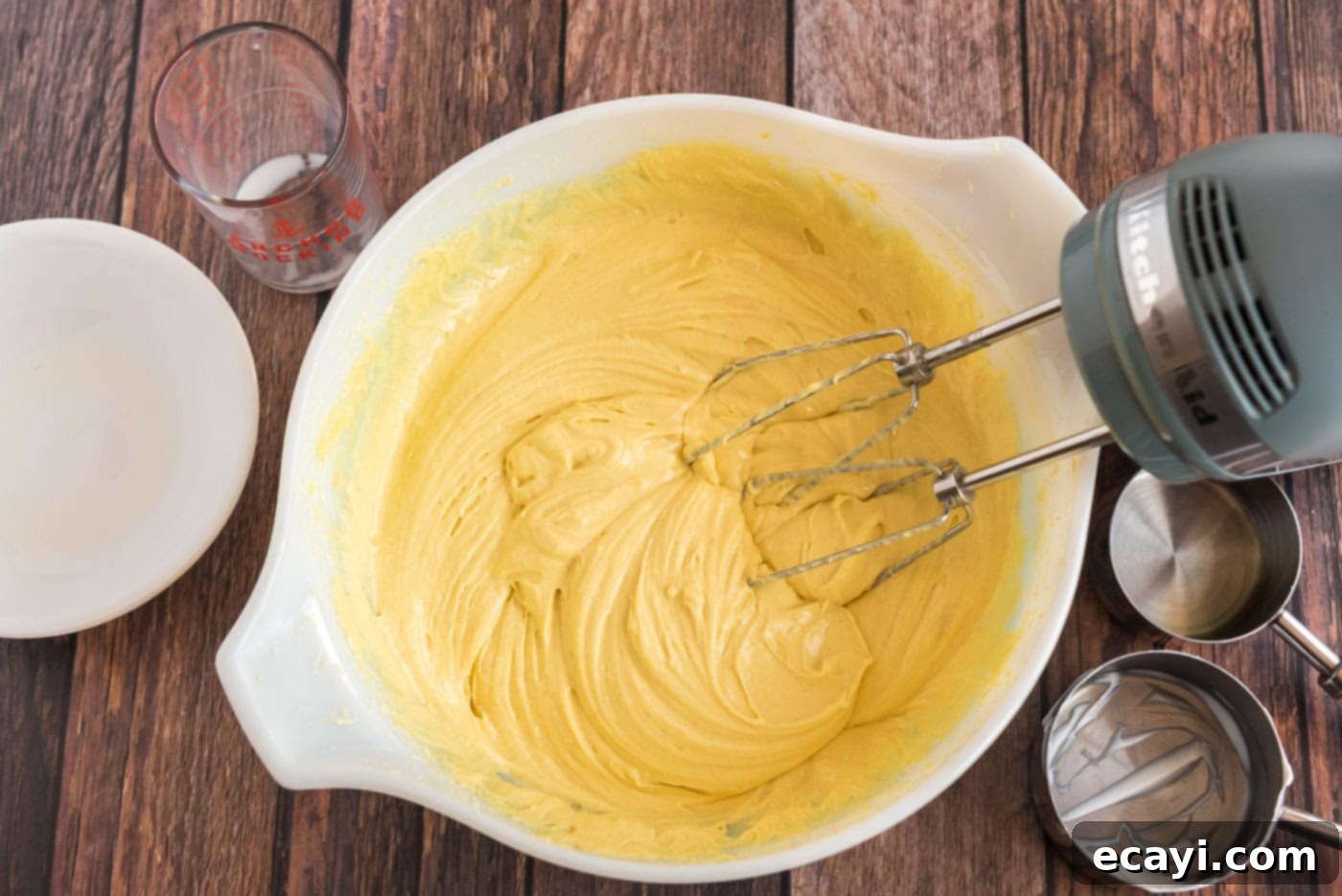 Tender Blueberry Cake with Zesty Lemon Glaze 5 lemon cake batter in a mixing bowl with whisk beaters