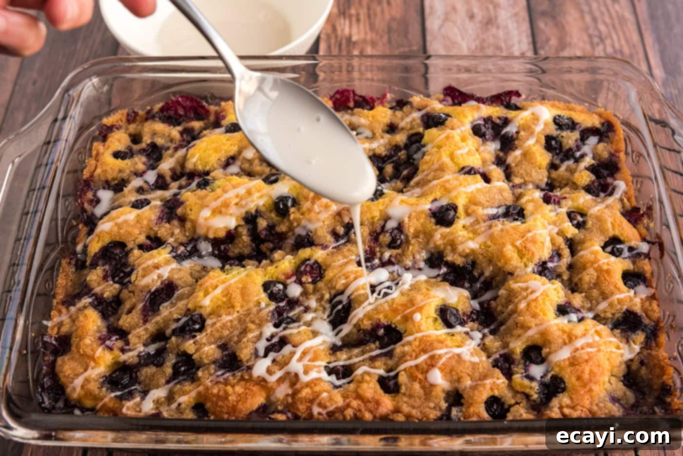 Tender Blueberry Cake with Zesty Lemon Glaze 10 drizzling glaze over lemon blueberry cake