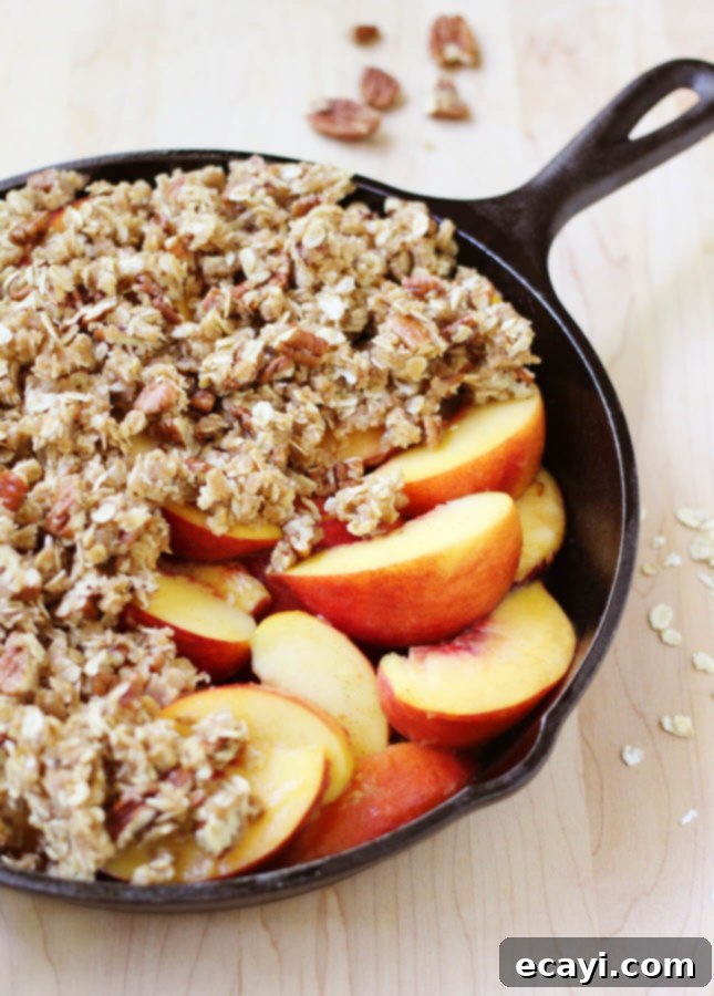 Bourbon-Kissed Peach Crumble 4 This aromatic Bourbon Peach Crisp combines classic southern ingredients to produce a dessert that marries jammy fruits and a crunchy topping. // Bourbon Peach Crisp // FoodNouveau.com