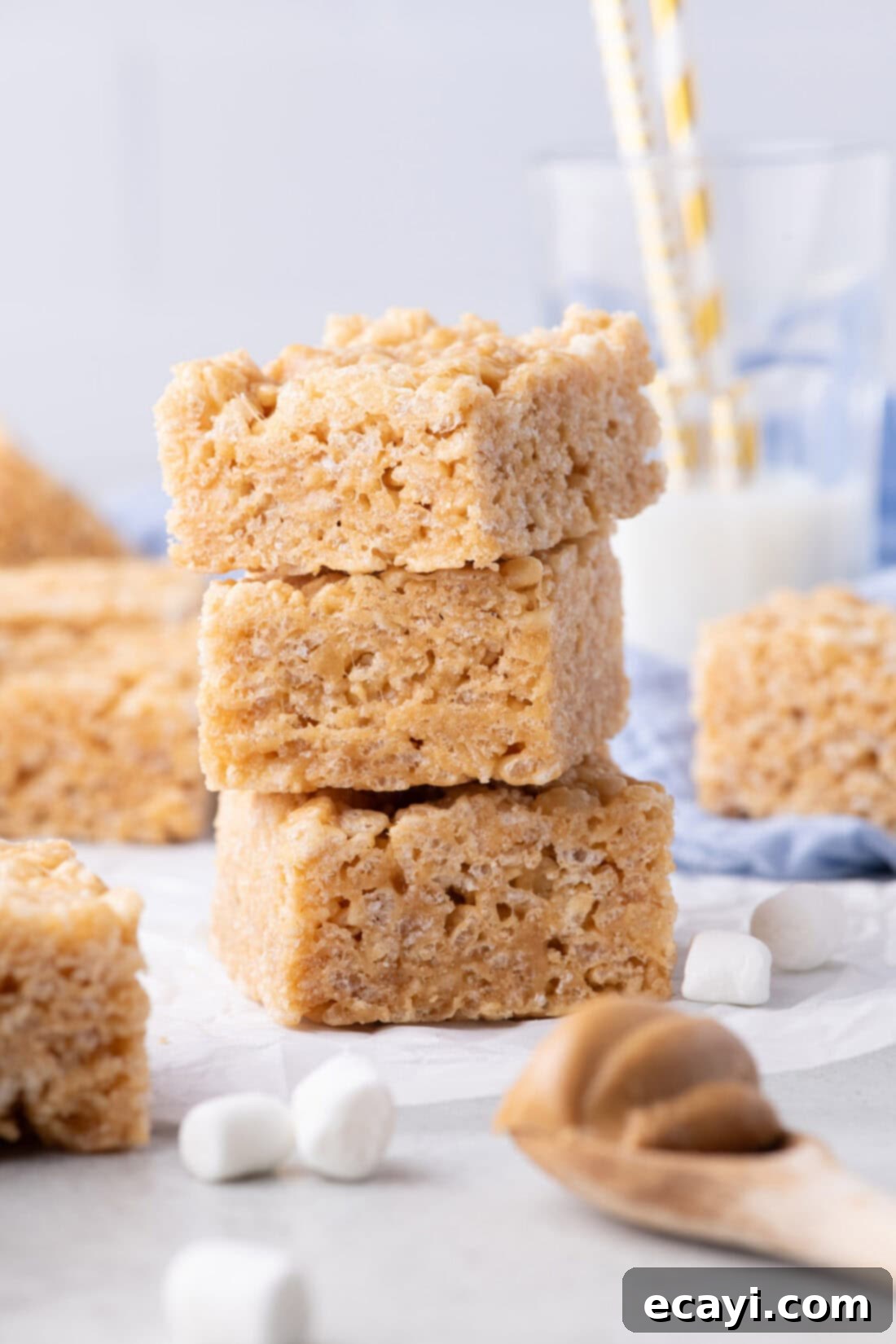 Crunchy Peanut Butter Krispie Delights 2 Stack of three Peanut Butter Rice Krispie Treats, showcasing their golden color and tempting texture.