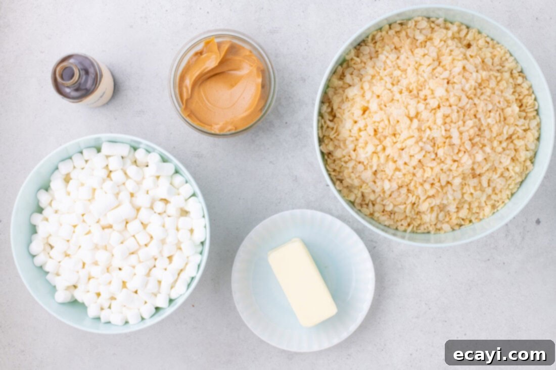 Crunchy Peanut Butter Krispie Delights 4 A visual display of the simple ingredients needed for Peanut Butter Rice Krispie Treats: butter, peanut butter, vanilla extract, marshmallows, and Rice Krispies cereal.