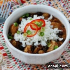 Vibrant Three Bean Salsa Chicken and Rice 9 A close up of a white bowl filled with three bean salsa chicken and rice.