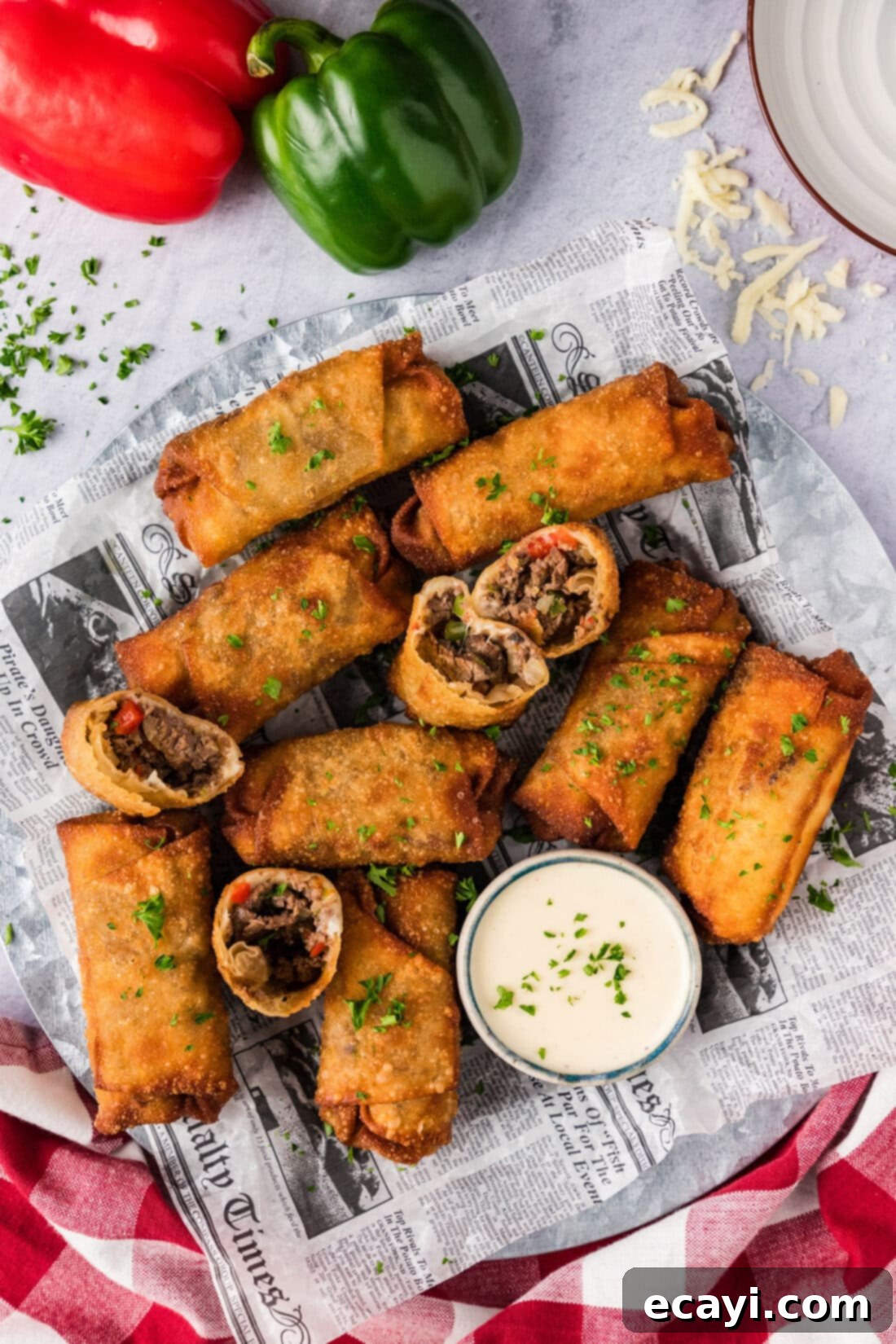 Crispy Philly Cheesesteak Rolls 2 Platter of Philly Cheesesteak Egg Rolls with a bowl of cheese sauce on the side
