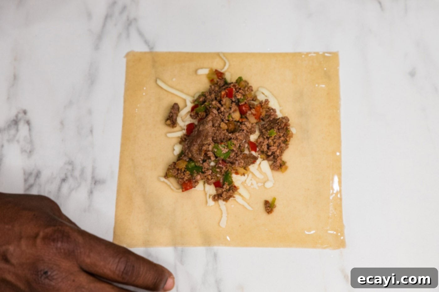 Crispy Philly Cheesesteak Rolls 11 wetting sides of egg roll wrapper with water