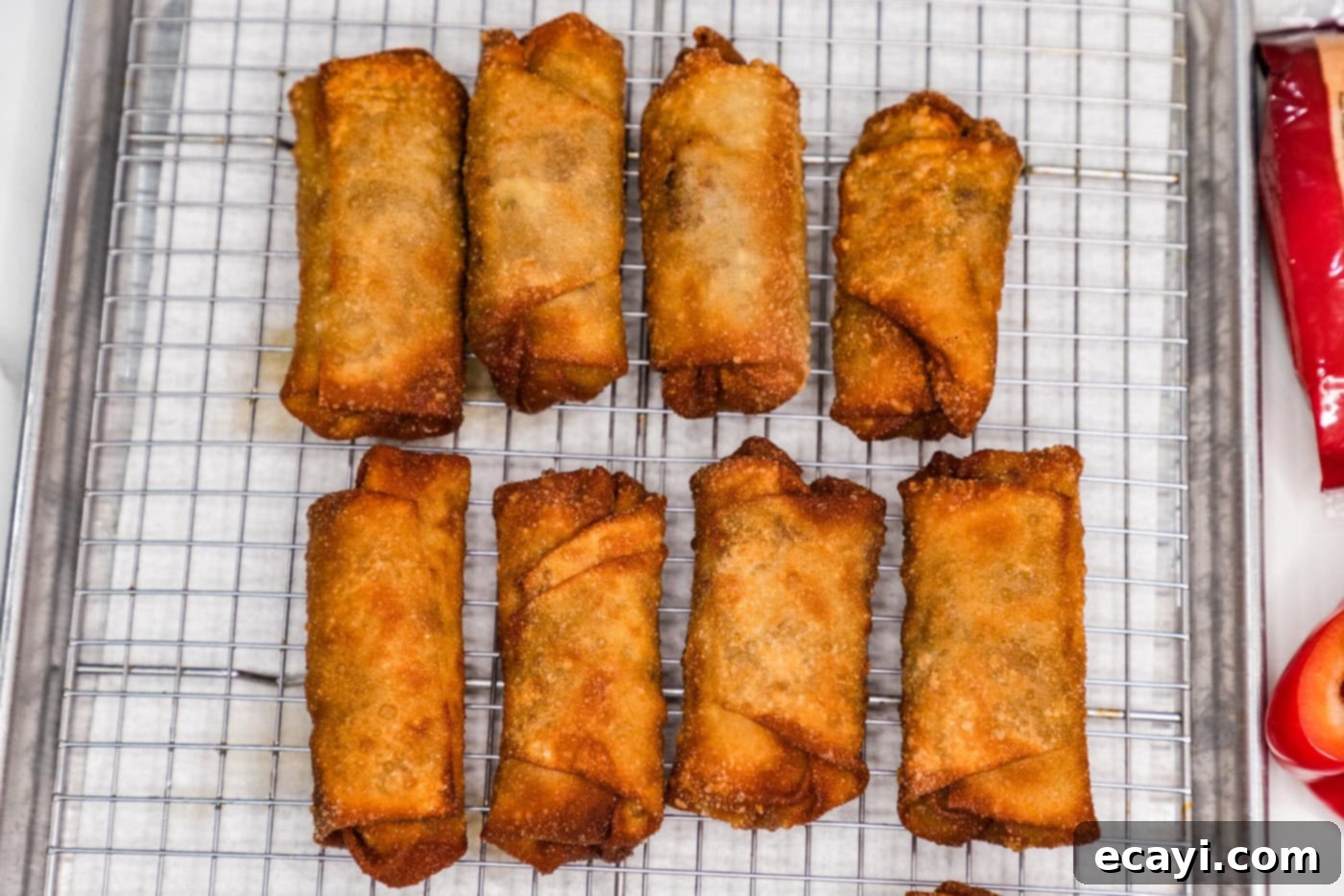 Crispy Philly Cheesesteak Rolls 15 fried philly cheesesteak egg rolls on a wire rack