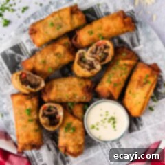Crispy Philly Cheesesteak Rolls 17 Close up photo of a platter of Philly Cheesesteak Egg Rolls