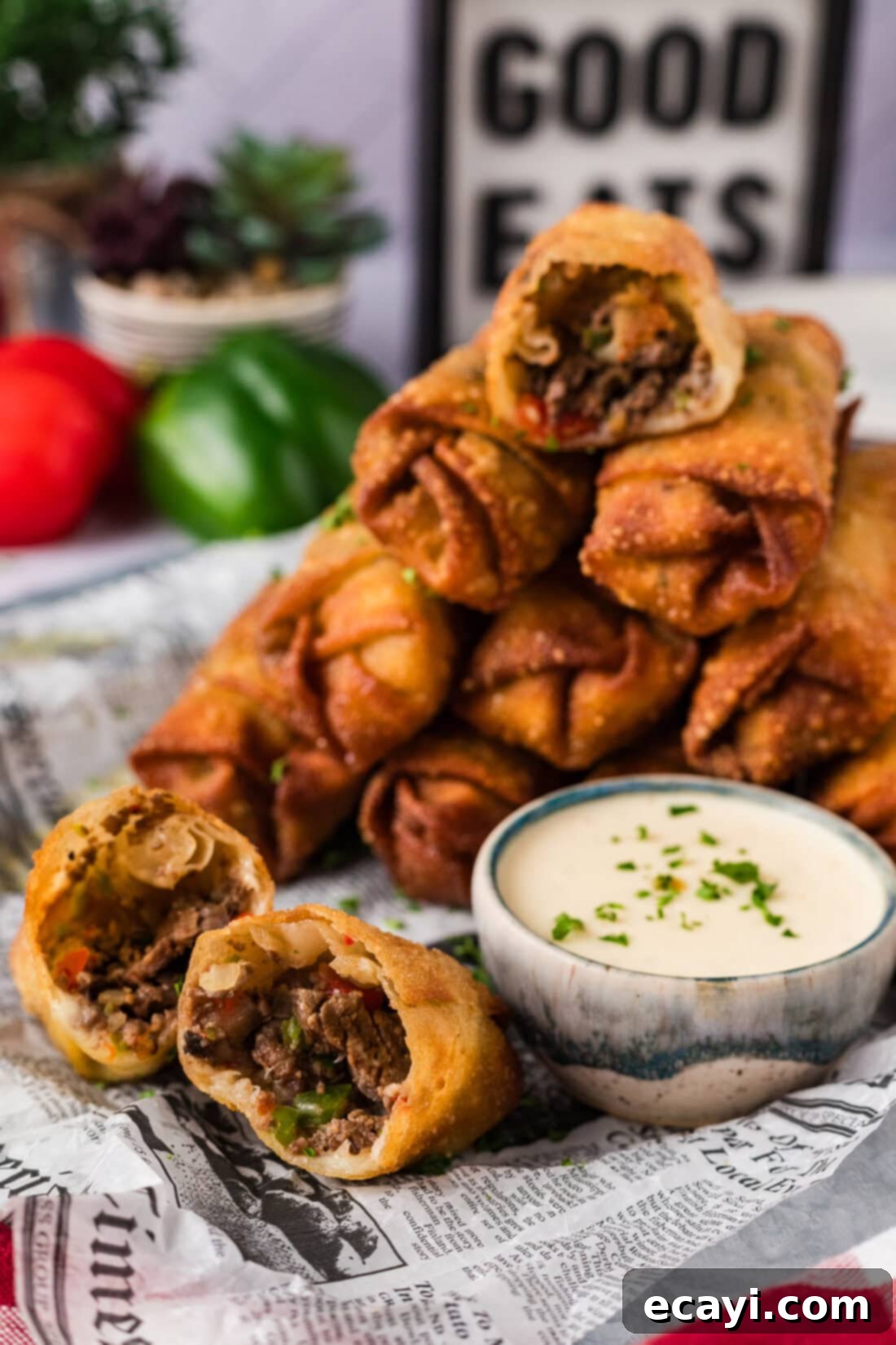 Crispy Philly Cheesesteak Rolls 3 Stack of Philly Cheesesteak Egg Rolls with one cut in half