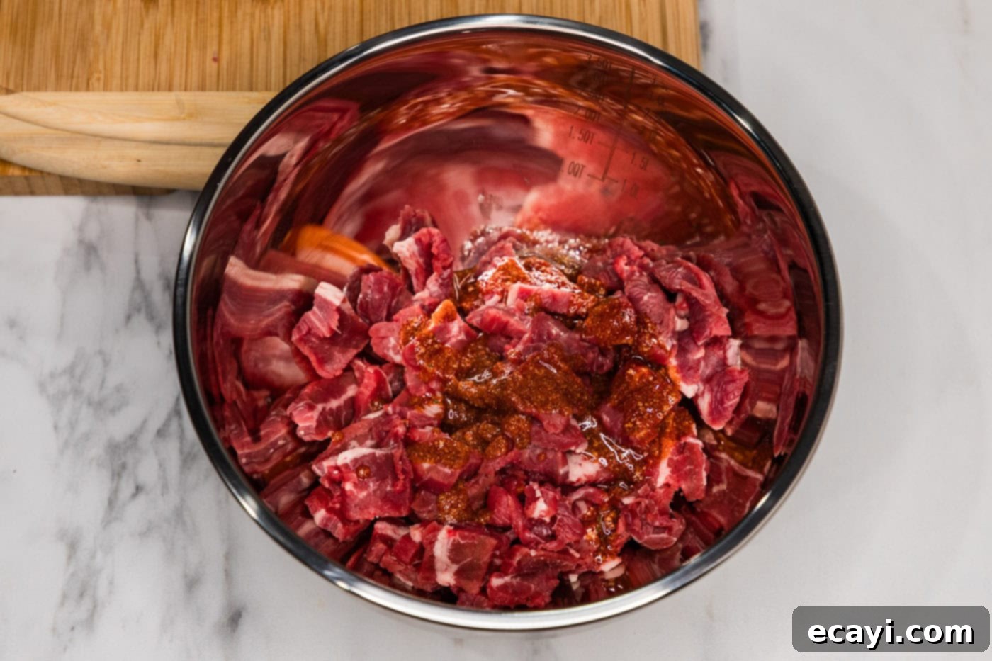 Crispy Philly Cheesesteak Rolls 5 sliced steak in a bowl with olive oil and seasonings