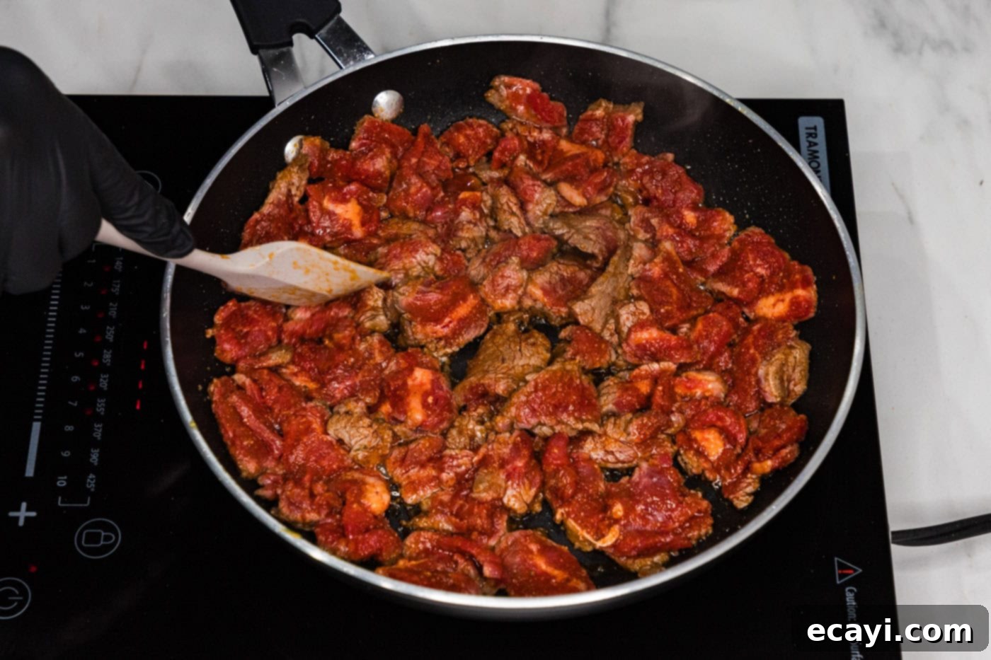 Crispy Philly Cheesesteak Rolls 6 cooking steak in a skillet