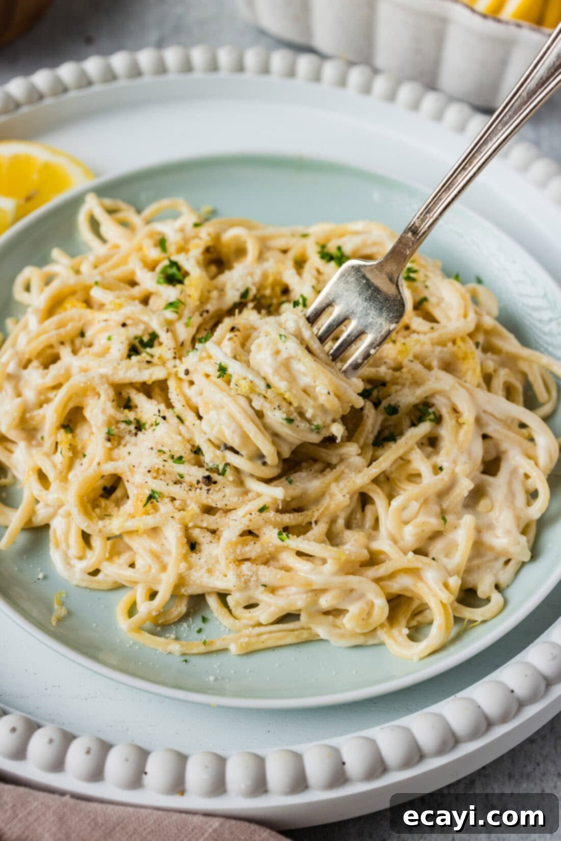 Zesty Lemon Cream 3 Pasta being twirled around a fork, coated in a rich lemon cream sauce.