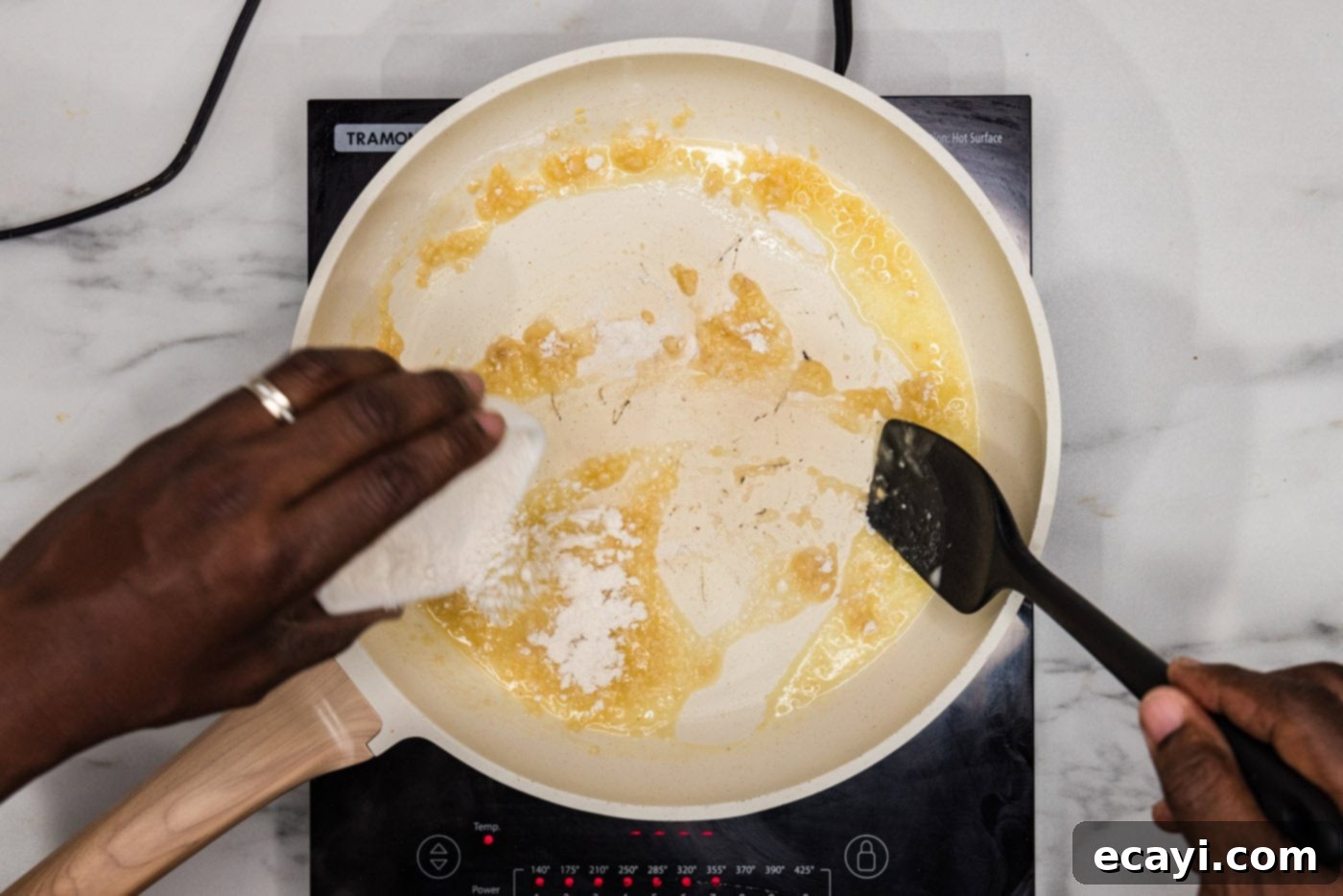 Zesty Lemon Cream 5 Sprinkling flour into a skillet with butter and garlic, forming a roux.