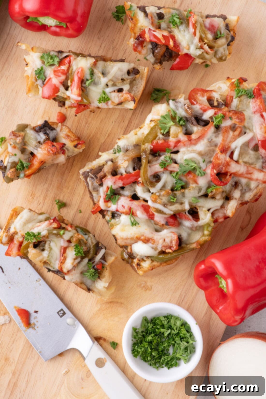 Philly Cheesesteak Pull-Apart Bread 3 Philly Cheesesteak Cheesy Bread cut into slices on a wooden cutting board