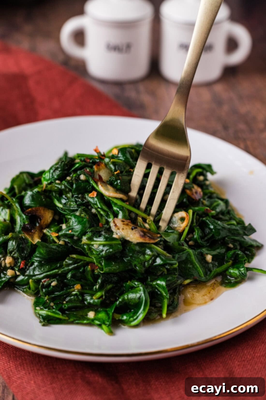 Wok-Kissed Spinach 3 Fork in a pile of Stir Fried Spinach