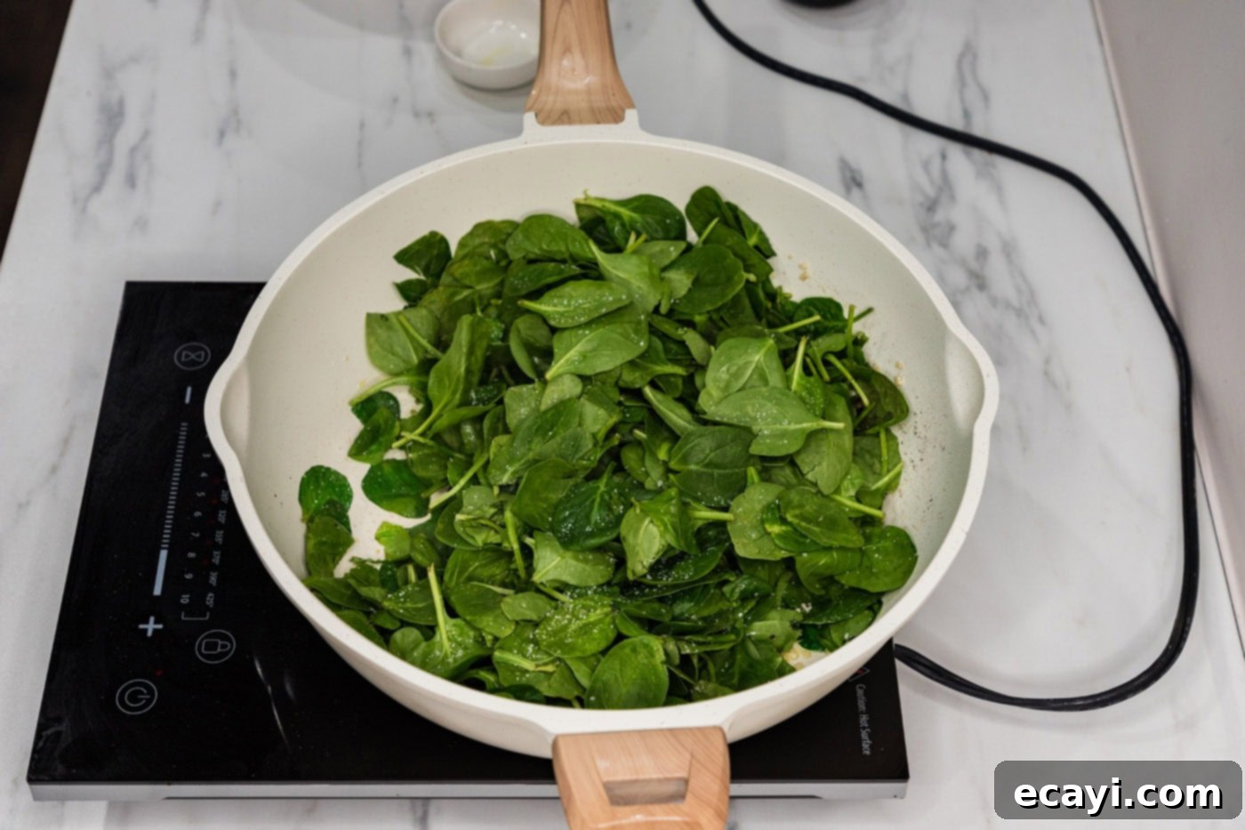 Wok-Kissed Spinach 5 spinach in a skillet