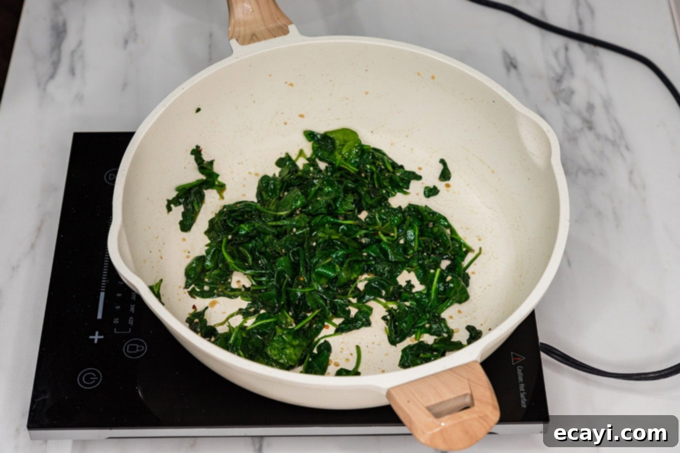 Wok-Kissed Spinach 6 wilted spinach in a skillet