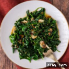 Wok-Kissed Spinach 8 Plate of Stir Fried Spinach with a fork resting to the side