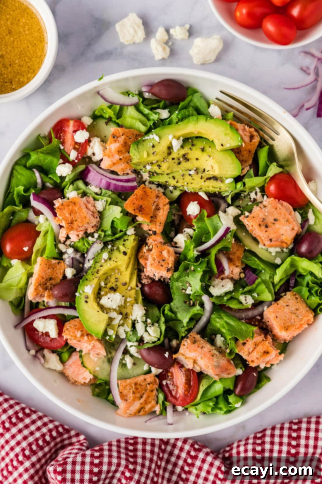 Fresh Salmon Medley 2 Bowl of Salmon Salad with tomatoes, dressing and feta to the side