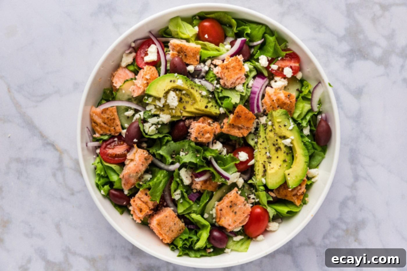 Fresh Salmon Medley 6 avocado, feta, and salmon added to salad in a bowl