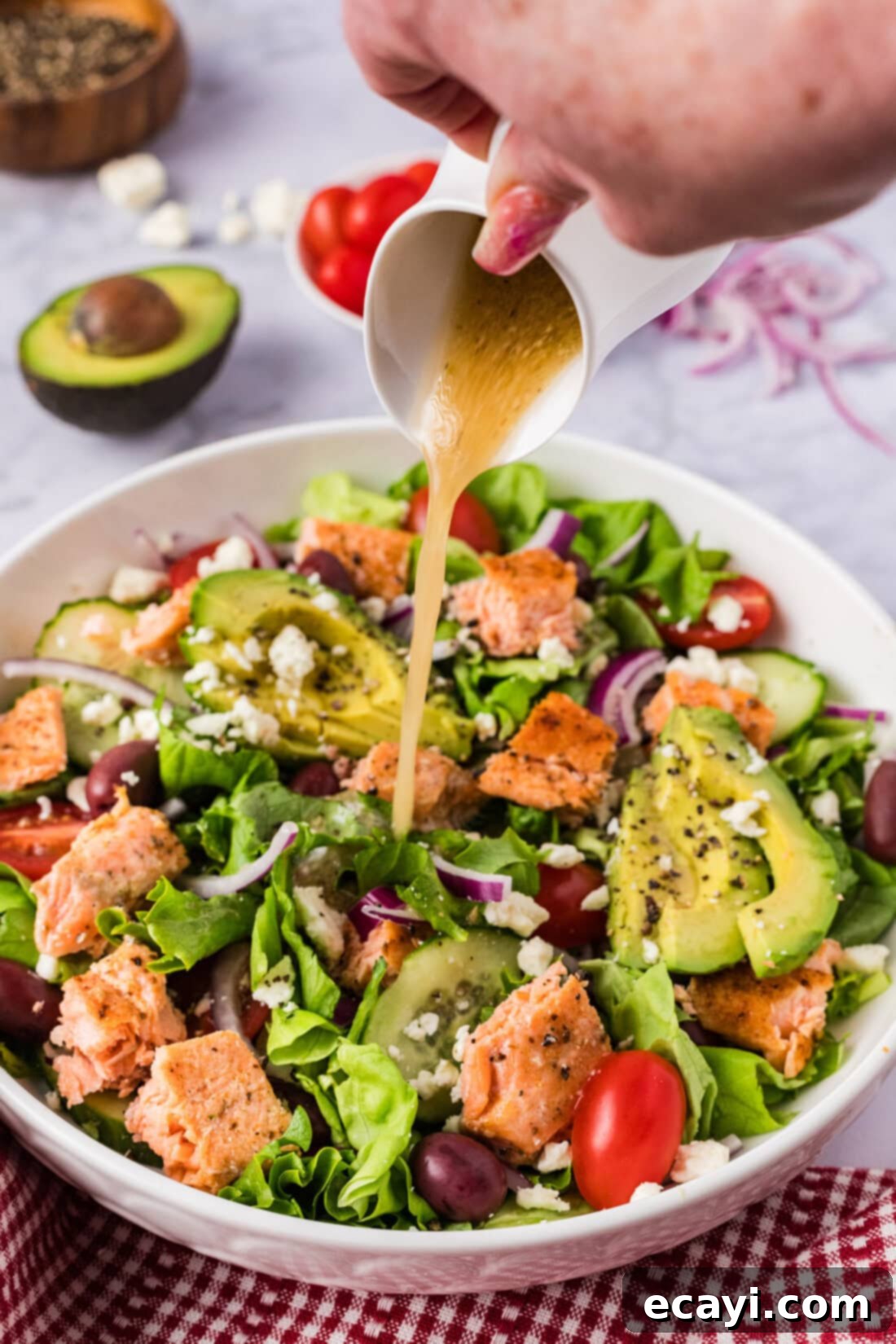 Fresh Salmon Medley 7 Dressing being poured over Salmon Salad