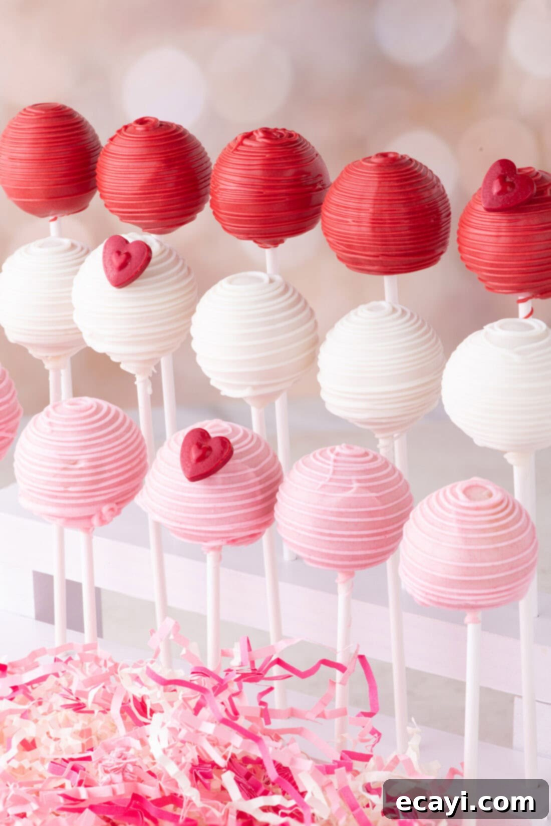 Sweetheart Cake Pops 12 A collection of vibrantly colored Valentine Cake Pops arranged neatly on a multi-tiered cake pop stand