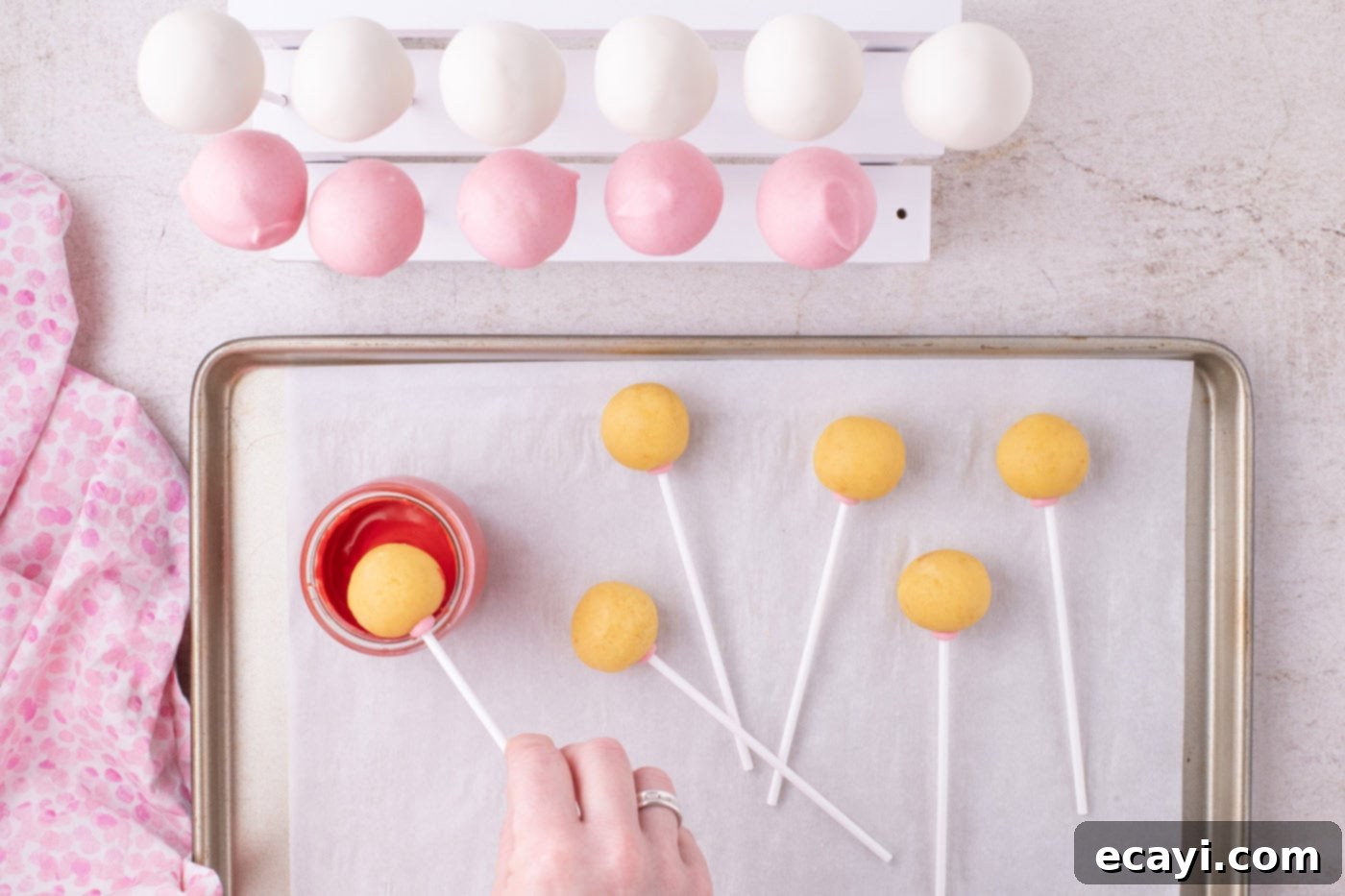 Sweetheart Cake Pops 10 A Valentine Cake Pop being dipped into smooth, vibrant red chocolate coating
