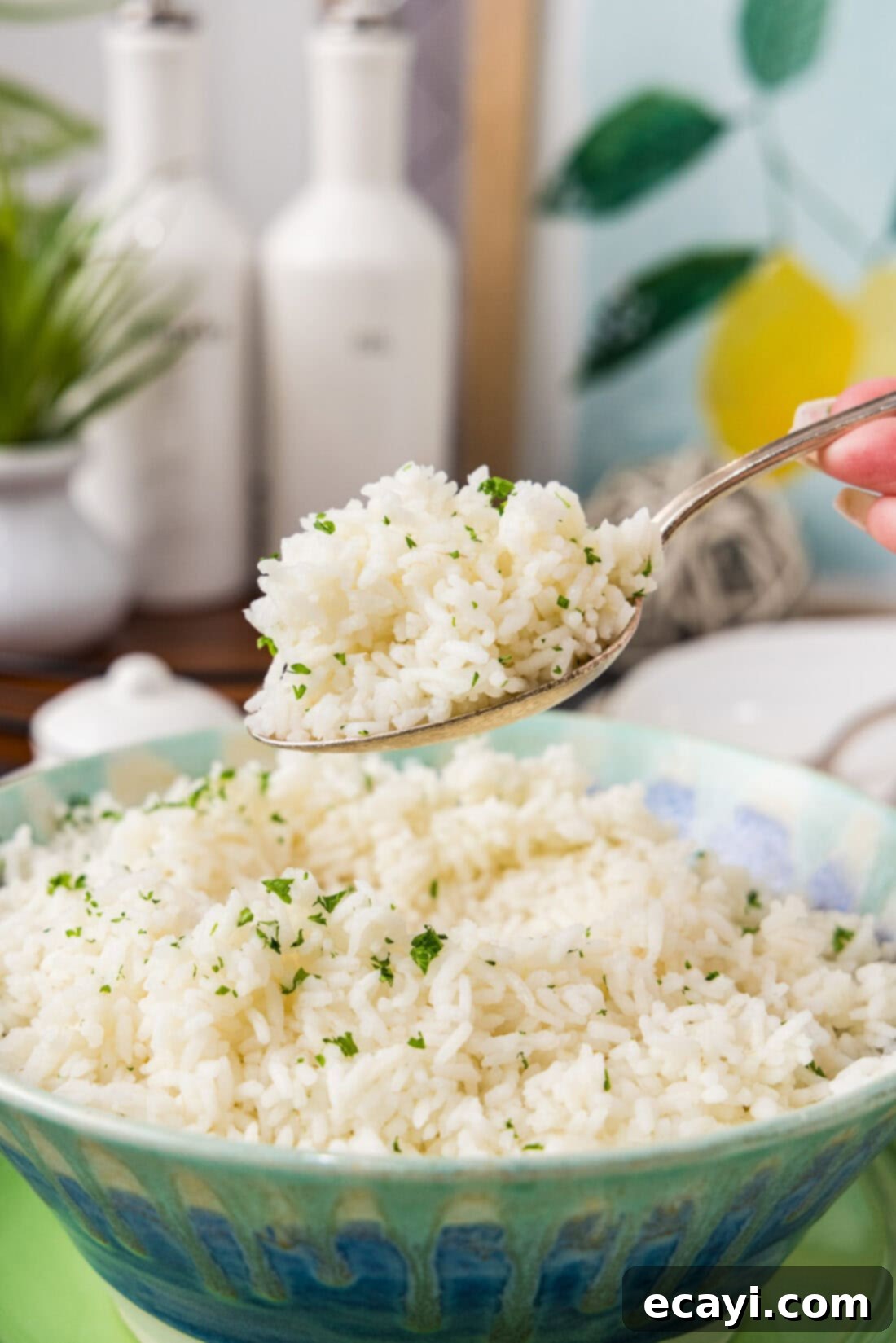 Pasta-Style Rice 2 Spoonful of Pasta Method Rice held above a bowl of Pasta Method Rice