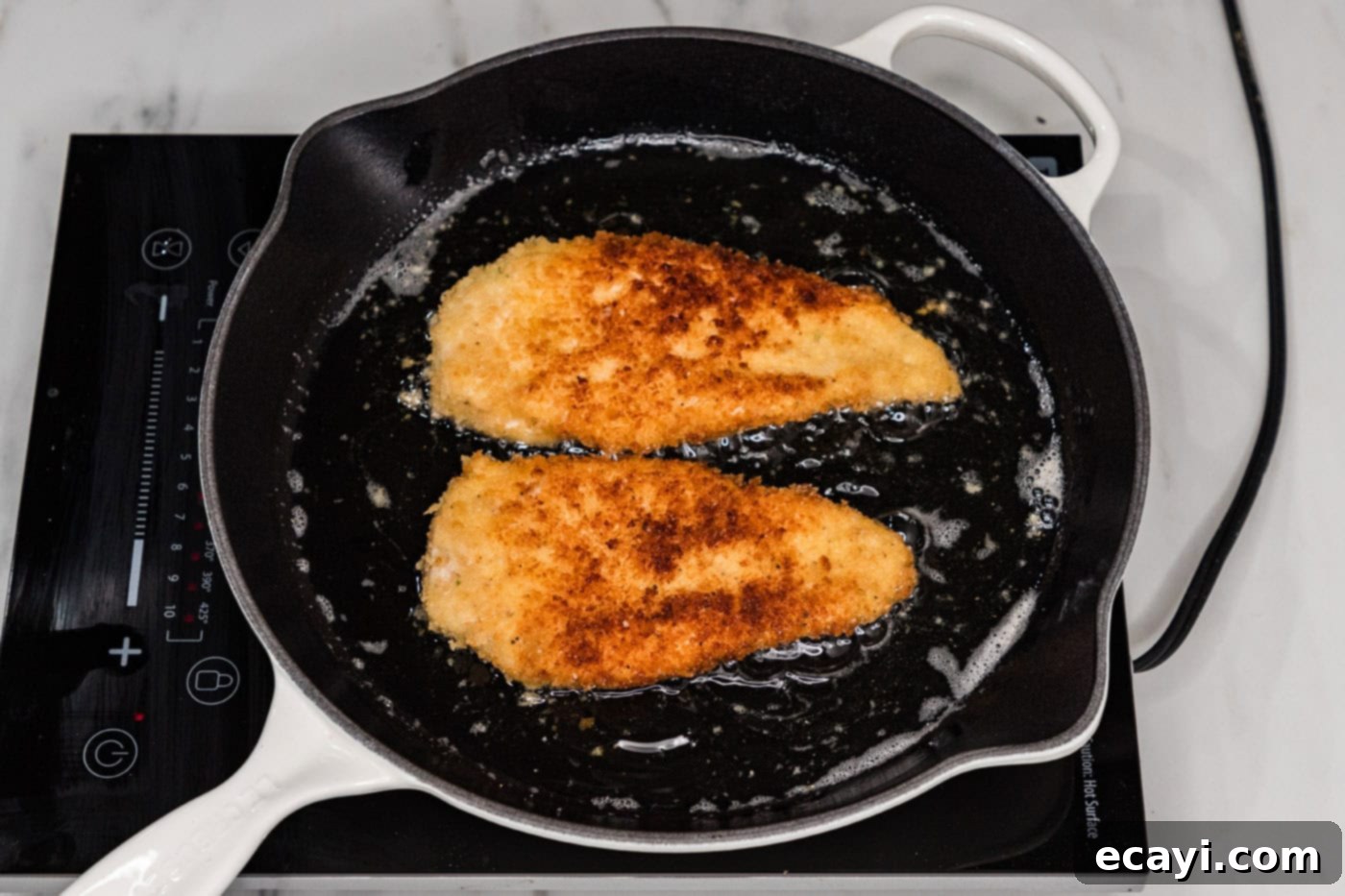 Golden Panko Chicken Cutlet 11 frying panko chicken in a skillet of oil